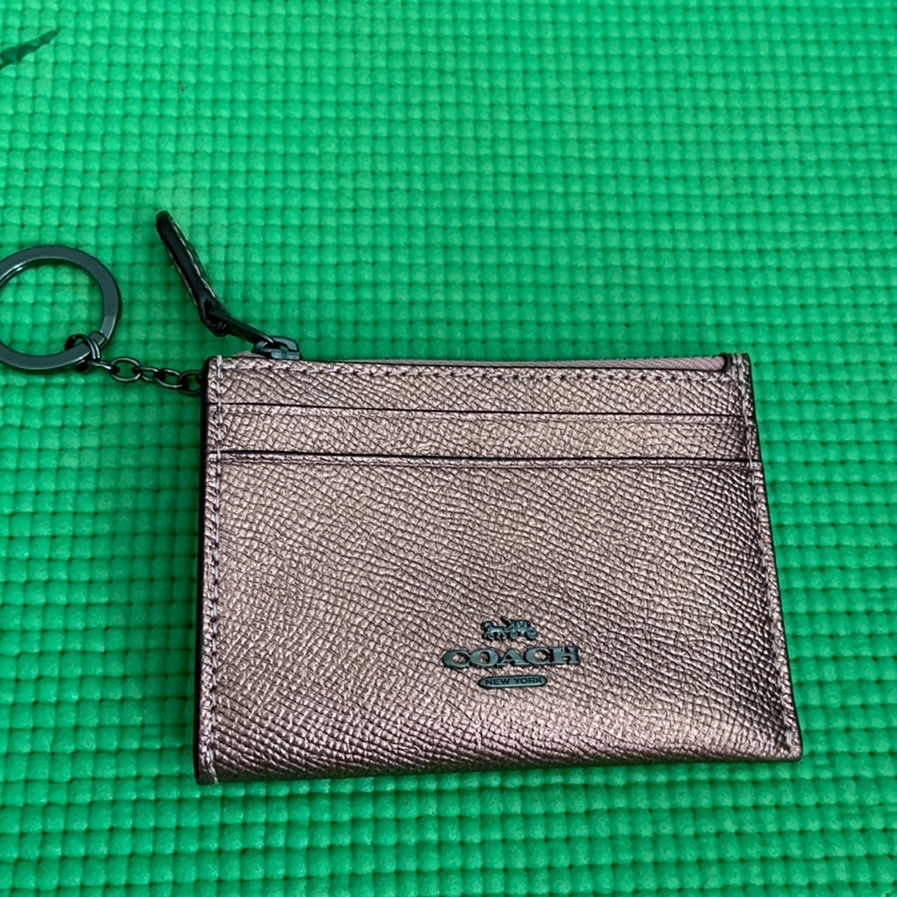 Coach rose gold ID keychain.